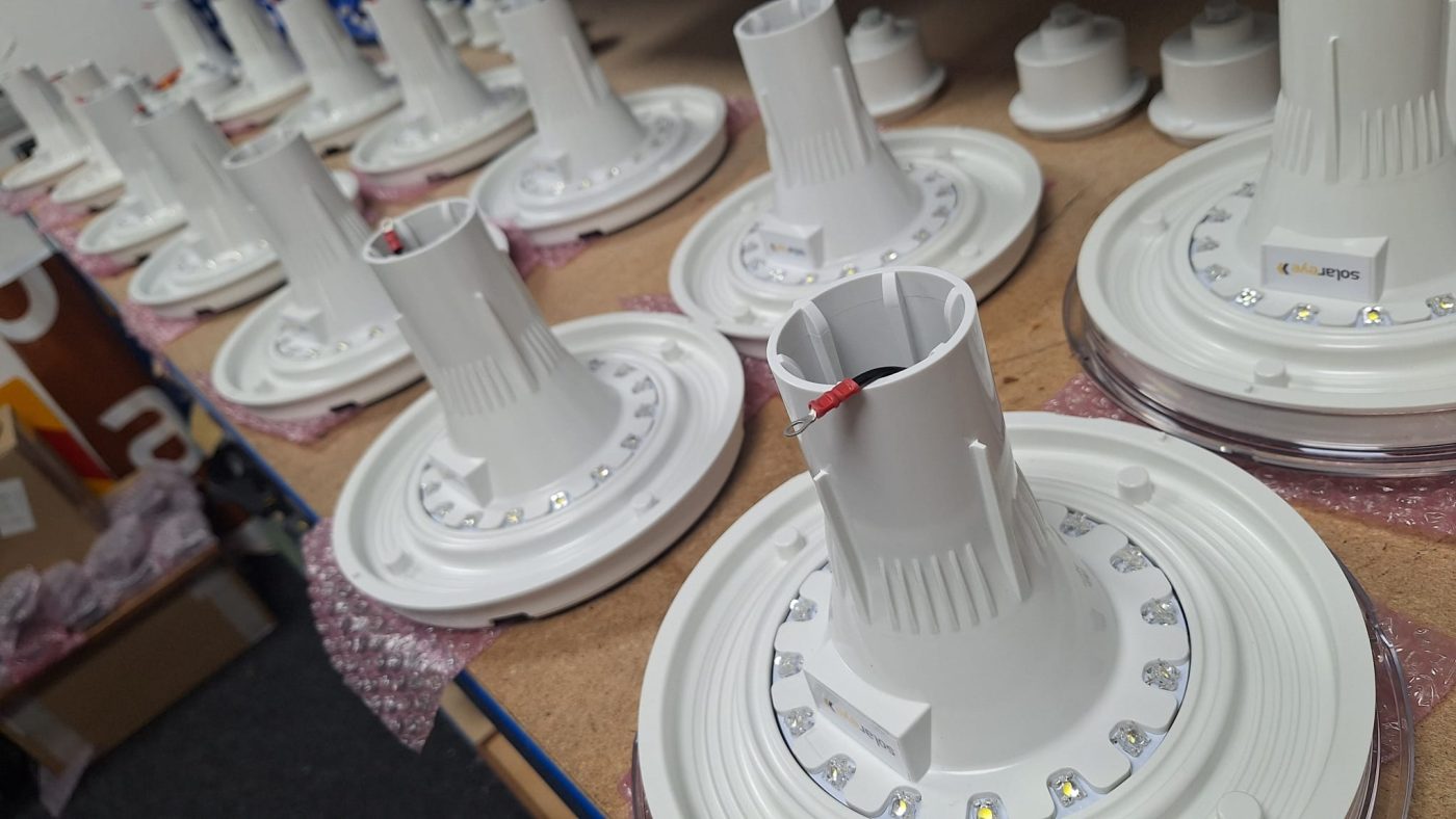 Solar bollard components in a factory setting.